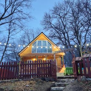 a small house with a fence in front of it at Wooden House Kopiti in Tbilisi City