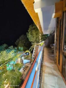a balcony with a view of a pool at night at Wonderful Homestay in Kasauli