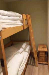 a couple of bunk beds in a room with a table at Cosy and spacious family nest with superb view in Courchevel