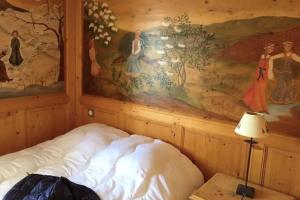 1 cama en una habitación con un cuadro en la pared en Cosy and spacious family nest with superb view, en Courchevel