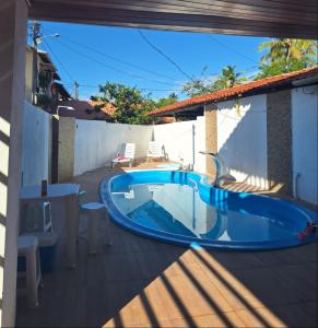 a swimming pool in the middle of a patio at Paraíso da Deise in Mata de Sao Joao