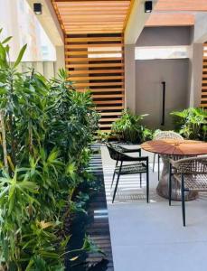 a patio with tables and chairs and plants at Infinity Tower Flat - 1403 in Itapema +10 photos