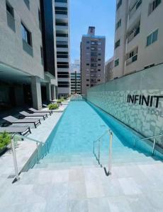 a swimming pool in the middle of a building at Infinity Tower Flat - 1403 in Itapema