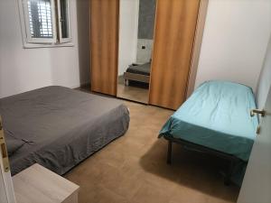 a bedroom with a bed and a door with a mirror at I Due Olmi in Modena