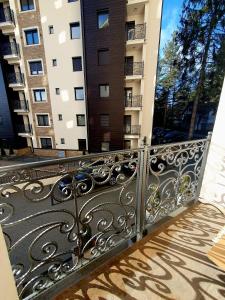 a balcony with a wrought iron railing in front of a building at Apartman Felicita 2 in Zlatibor
