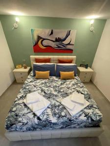 a bedroom with a bed with a blue and white comforter at Casa Mozza vicino Firenze in Sesto Fiorentino