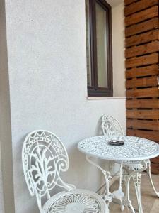 two chairs and a table and a table and chairs at House4You - Blănari 4 in Bucharest