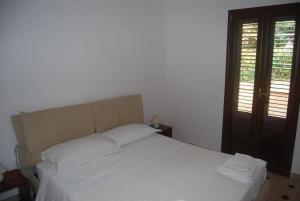 Ένα ή περισσότερα κρεβάτια σε δωμάτιο στο Villetta con giardino