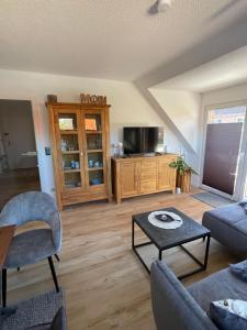 a living room with a couch and a table at Ferienwohnung Fehn in Rhauderfehn