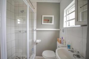 a bathroom with a shower and a toilet and a sink at 30 on Oatlands Road in Grahamstown