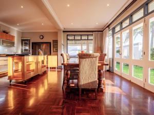a kitchen with a wooden table and a dining room at Dock Point 1 in Durban