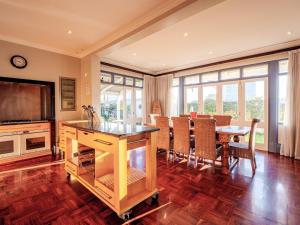 a living room with a dining table and a television at Dock Point 1 in Durban