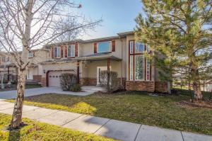a large house with a tree in the yard at Union Duplex Cove and Woods in Salt Lake with Hot Tub in Midvale