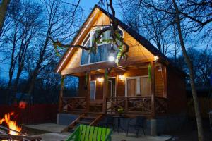 a tiny house in the woods with a fire at Wooden House Kopiti in Tbilisi City