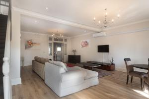 a living room with a couch and a table at Beach Haven Townhouse in Durban