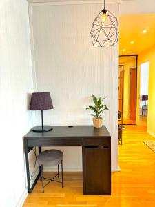 a desk with a lamp and a potted plant at Turku Downtown Cozy Flat with balcony 45m2 in Turku