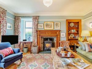 a living room with a couch and a fireplace at 4 Bed in Huntly 88855 in Inverurie