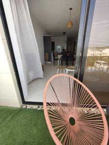 a pink fan sitting on top of a house at Seaside Serenity - A lovely apartment with views in Mellieħa
