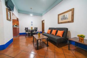 a living room with a couch and a table at Hotel Suites Del Centro in Oaxaca City