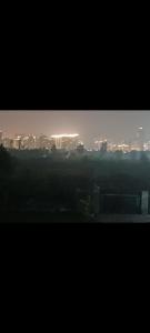a view of a city at night with at Sun n moon farm in Noida