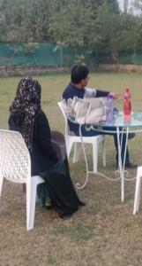 a couple of people sitting at a table at Sun n moon farm in Noida