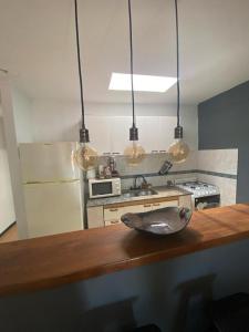 eine Küche mit einer Arbeitsplatte mit 3 Leuchten in der Unterkunft Departamentos PRANA in Villa Mercedes