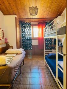 a room with two bunk beds and a window at Maison Palamos La Fosca in Palamós