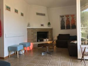 a living room with a couch and a fireplace at Maison Palamos La Fosca in Palamós