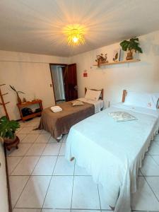 Tempat tidur dalam kamar di Naturaleza - Pousada & Centro Holístico