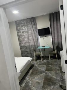 a bedroom with a bed and a table with chairs at Zerya suites in Istanbul