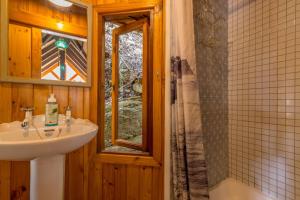 a bathroom with a sink and a shower at Ballots Bay Treehouse by Host Agents in George