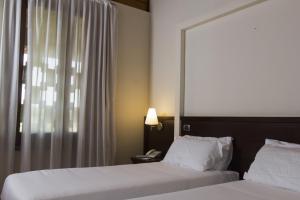 A bed or beds in a room at Country Hotel Castelbarco
