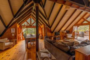 a large living room with a couch and a table at Ballots Bay Treehouse by Host Agents in George