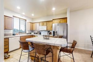 a kitchen with a large island with chairs around it at Happy Goose at Eagle Crest in Redmond