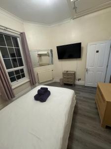 a bedroom with a bed and a flat screen tv at Valencia in Blackpool