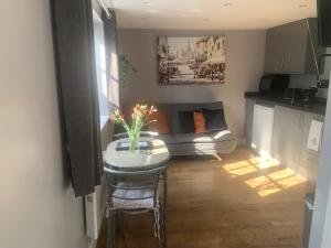 a small living room with a table and a couch at Scott’s lodge in Kent