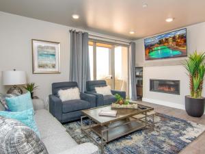 a living room with a couch and a fireplace at Sage Creek E1 in Moab with Scenic Community Pool in Moab