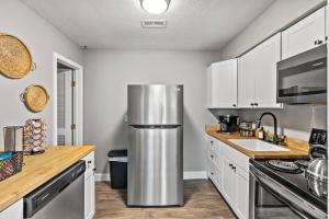 a kitchen with a stainless steel refrigerator in it at The Luxe/ Hot Tub/ On Bright Leaf Golf Course in Harrodsburg
