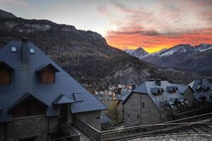 エスカリリャにあるMimosa 4 con terraza - tucasaenlospirineosの山を背景にした町の夕日
