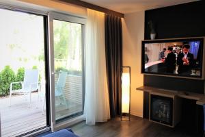 TV a/nebo společenská místnost v ubytování Privat & Boutique Hotel Plauer See