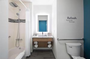 a bathroom with a sink and a toilet and a shower at EVEN Hotel Miami - Airport, an IHG Hotel in Miami