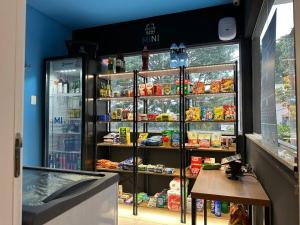 a store with a refrigerator with food and drinks at Cantinho da Paty in Florianópolis