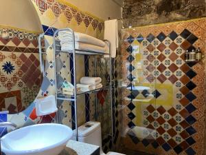 a bathroom with a shower and a toilet and a sink at Hotel Amor y Paz in Real de Catorce