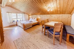 a bedroom with a bed and a table in a room at Bio-Bauernhof Auernig in Obervellach