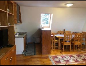 a kitchen and dining room with a table and chairs at Villa Aleksandra Jahorina in Jahorina