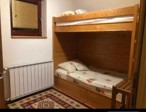 a room with two bunk beds and a rug at Villa Aleksandra Jahorina in Jahorina