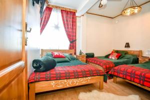 a room with two beds and a window at Domek u Zosi in Zakopane +193 photos