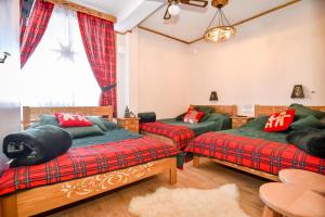 a living room with two beds and a couch at Domek u Zosi in Zakopane