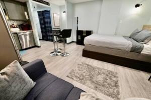 a bedroom with a bed and a couch in a room at Workspace Studio Ski In Ski Out Portable AC Included in Snowshoe