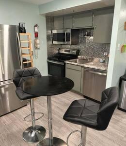 a kitchen with a black table and two chairs at Workspace Studio Ski In Ski Out in Snowshoe
